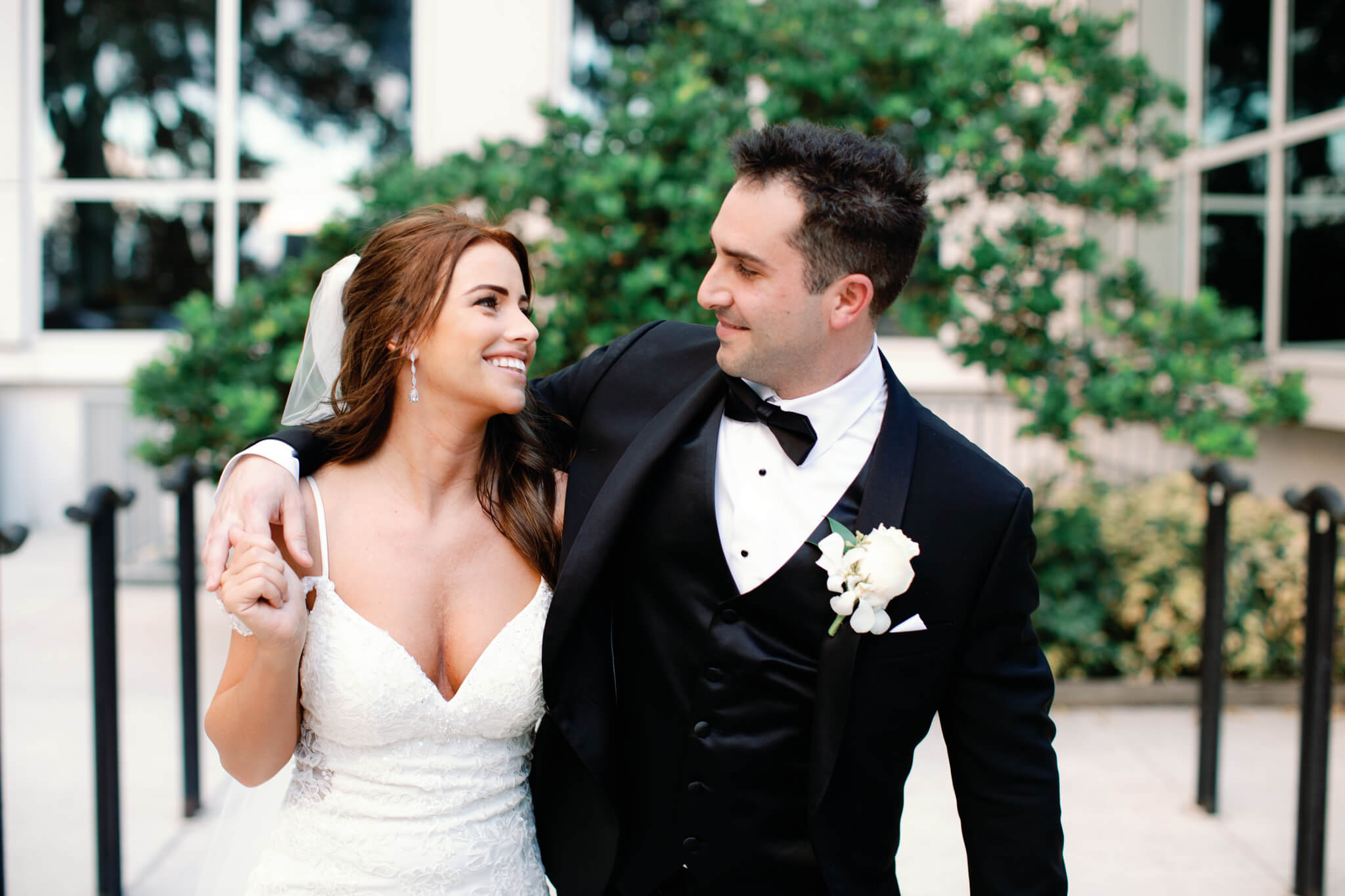 Bride and groom looking at each other and smiling in downtown Orlando