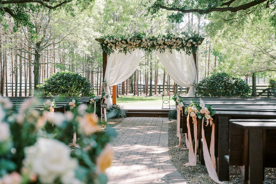 ceremony site decorated with flowers in a nature setting at a Florida wedding venue