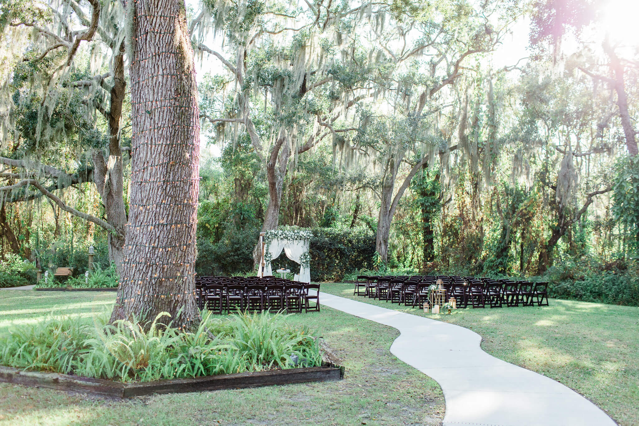 long winding isle leading to a ceremony site in a lush garden