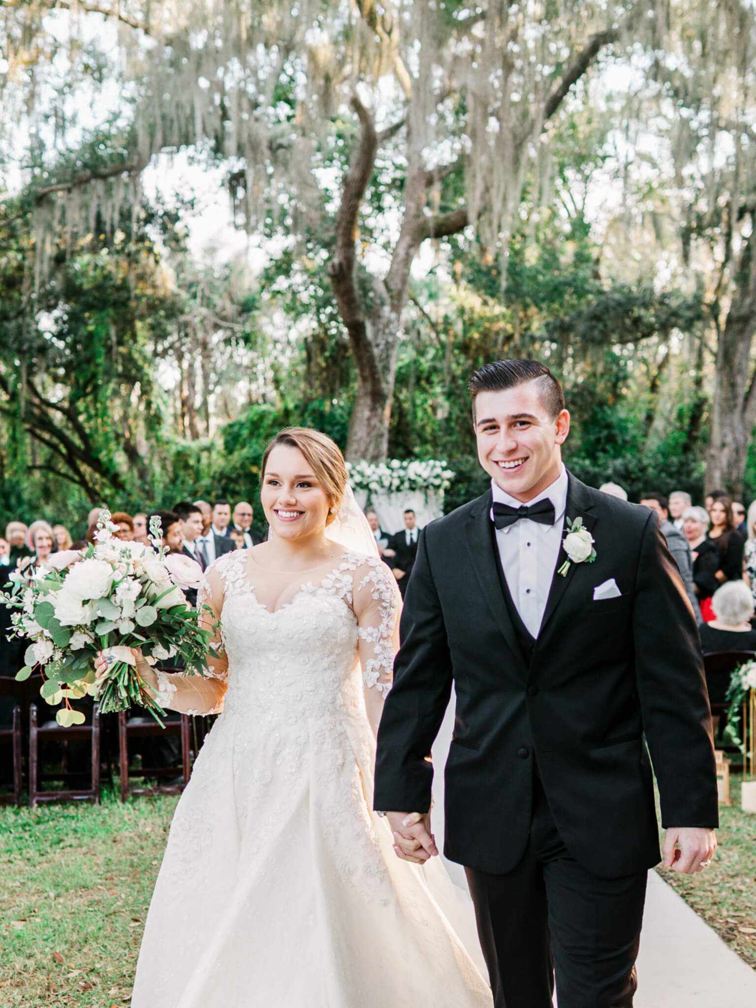 bride and groom exiting the wedding ceremony with big smiles