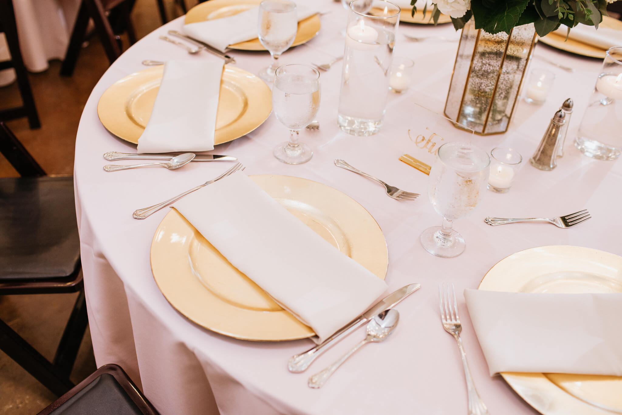 Close up of a table setting with pink linens