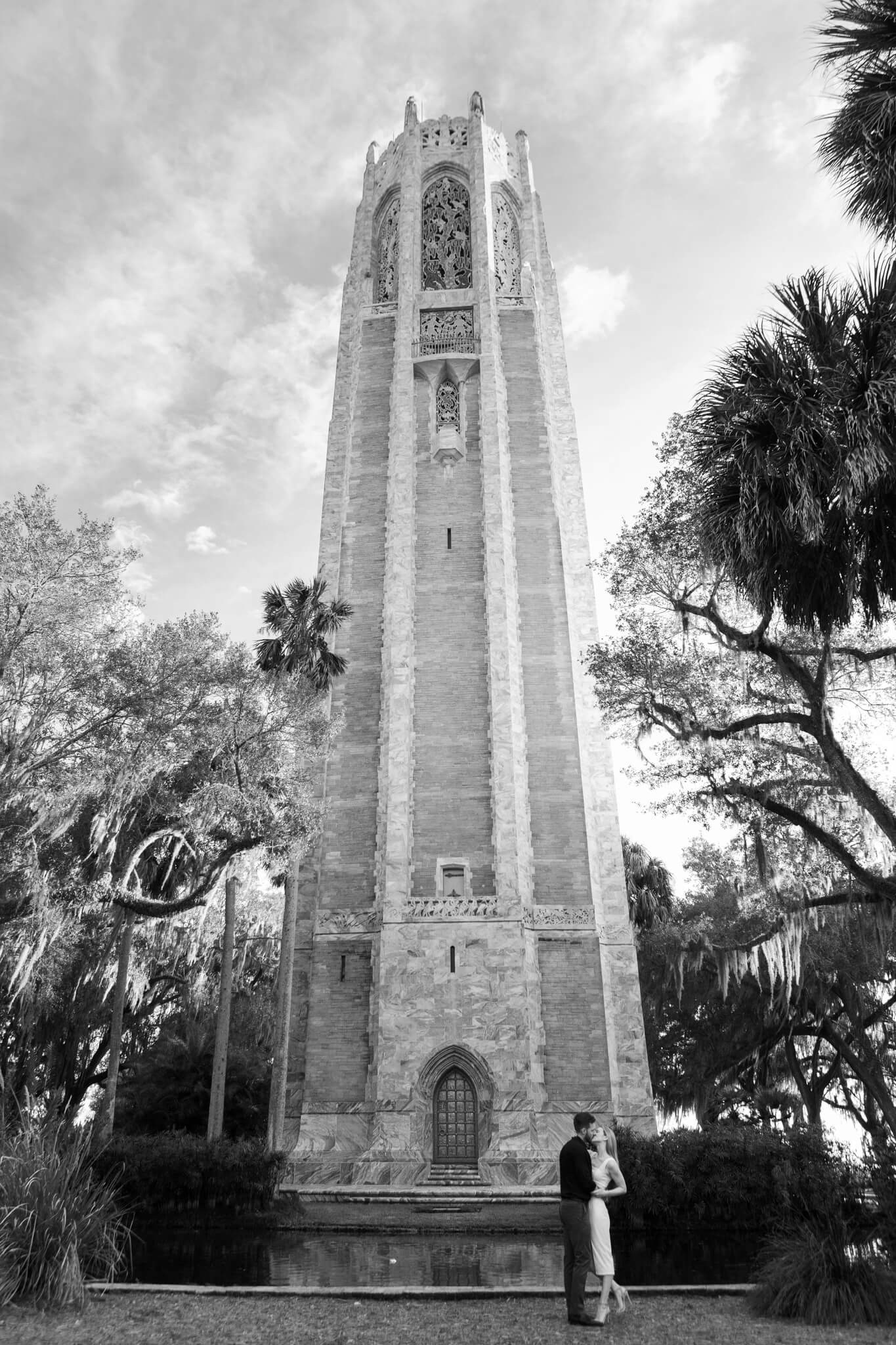Engaged couple poses in front of Bok Tower