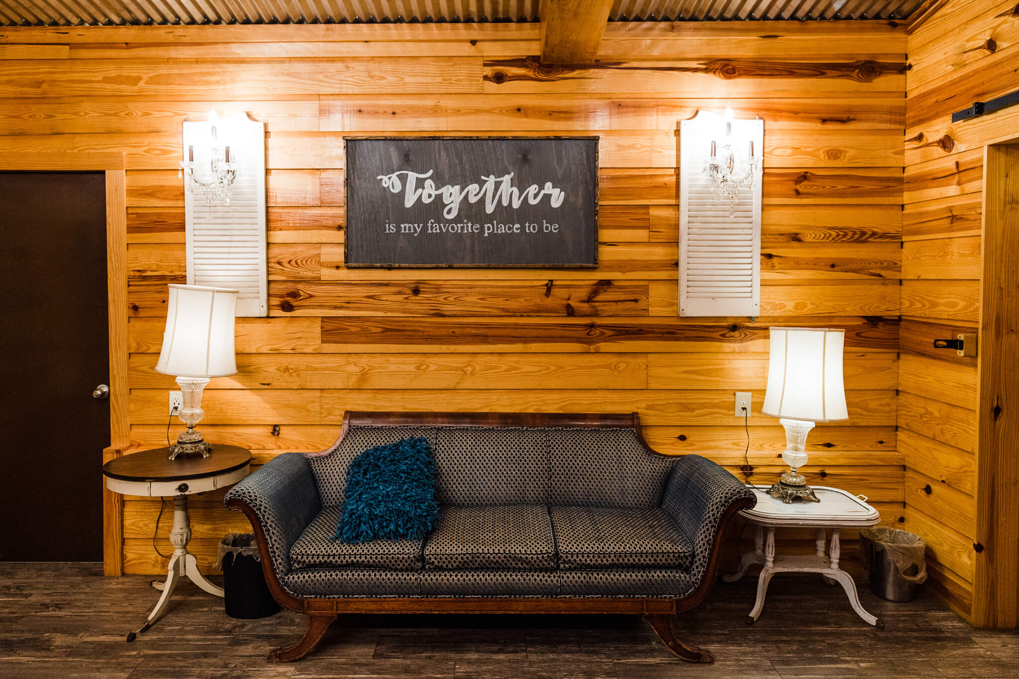Cloth couch in a bridal room with to table stands on each side with lamps on them at Club Lake, and outdoor wedding venue in Central FL