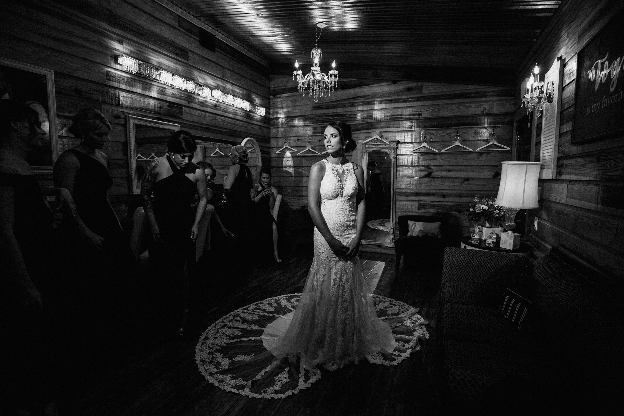 bride in wedding dress in getting-ready room in an outdoor wedding venue in central FL