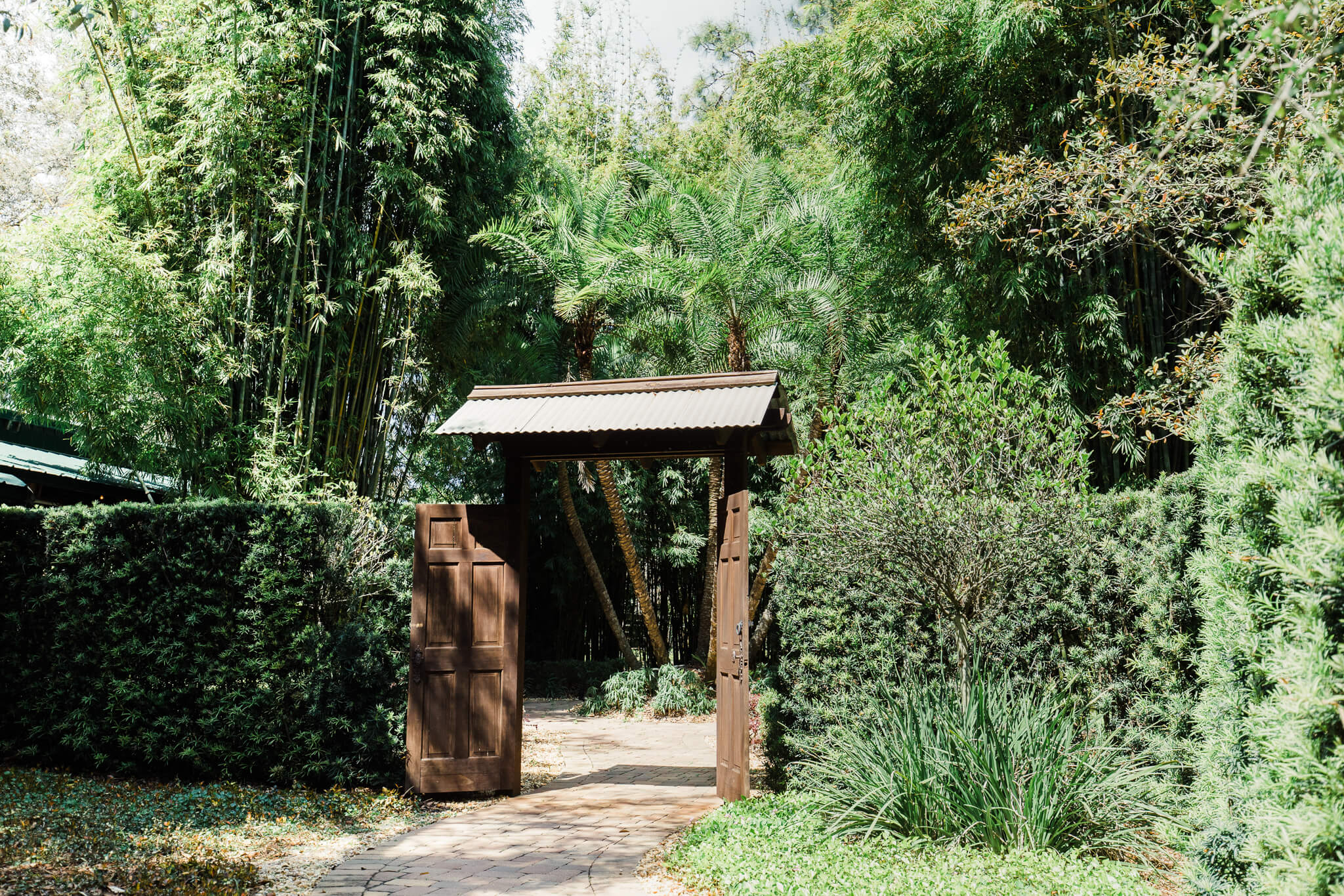 open wooden doorway to a secret garden at an outdoor wedding venue in Central FL