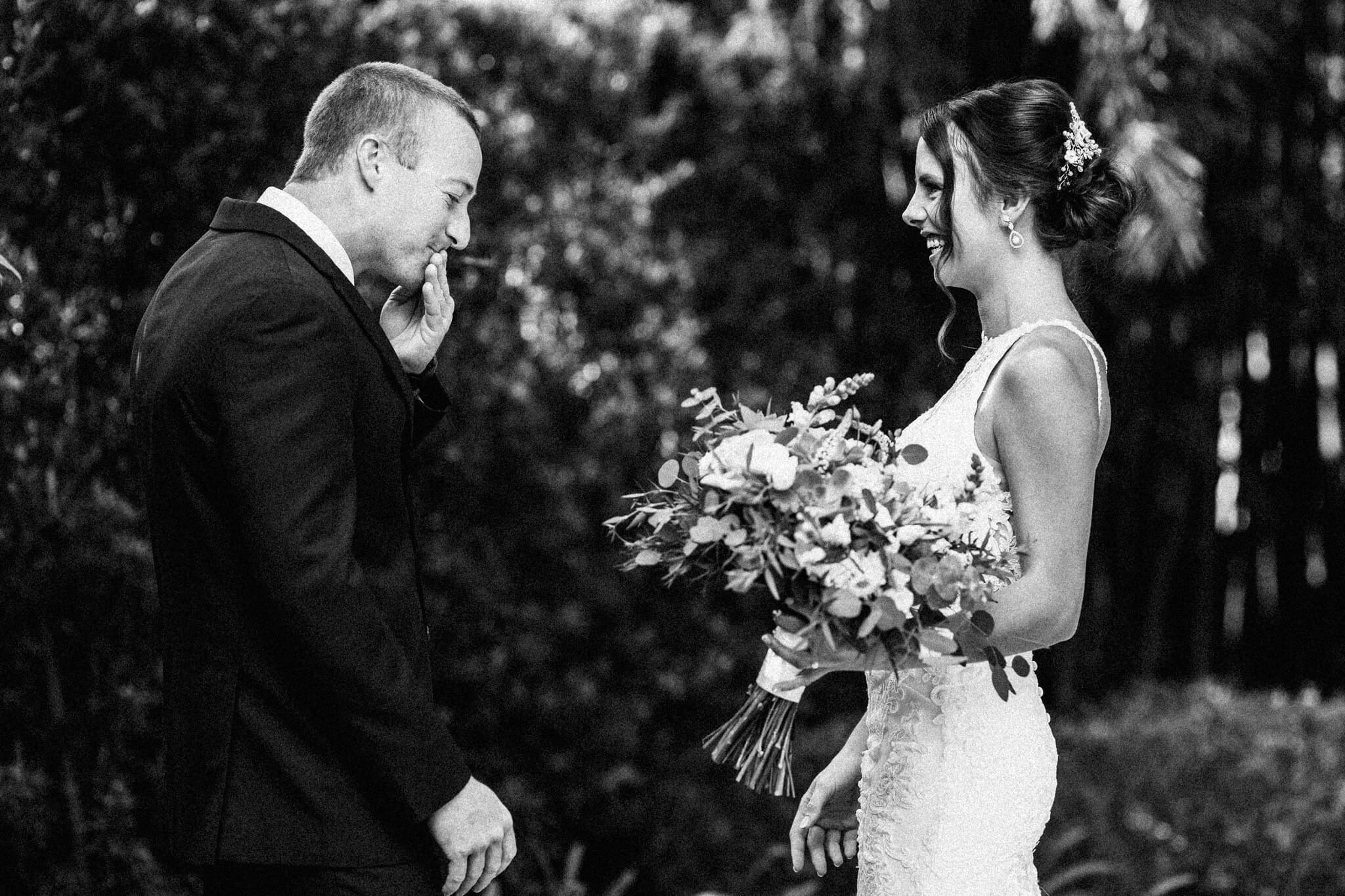 Groom reacts with amazement at seeing bride for the first time at an outdoor wedding venue in Central FL