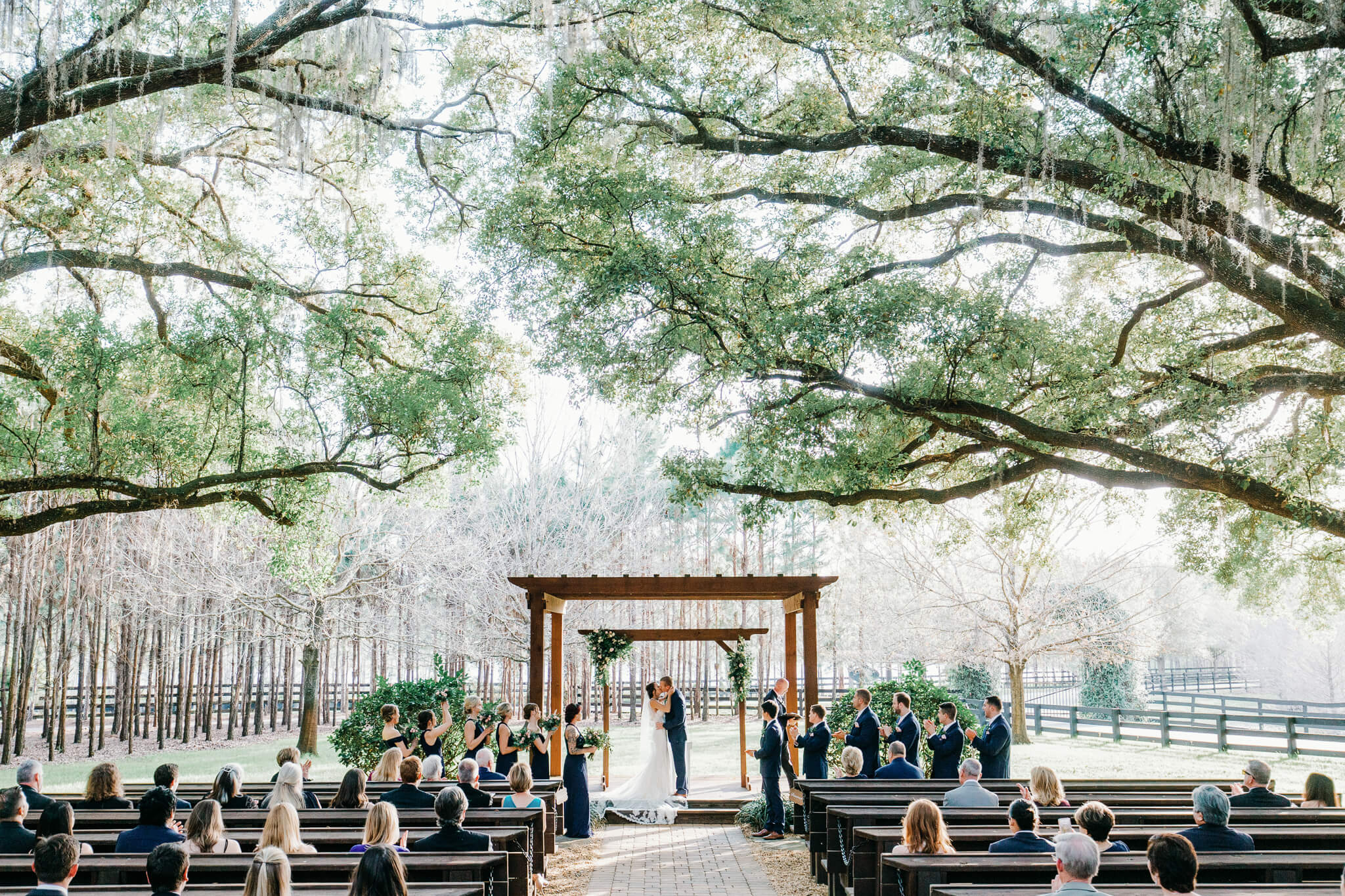 bride and groom have their first kiss at an outdoor wedding venue in Central FL