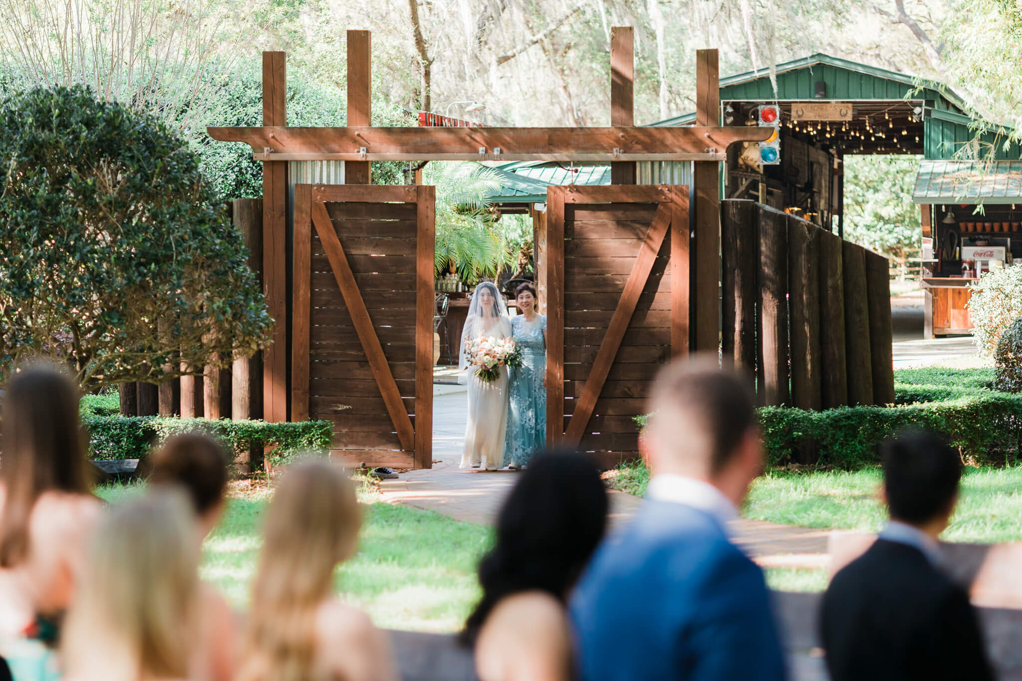Barn doors open at Club Lake revealing the bride coming down the isle