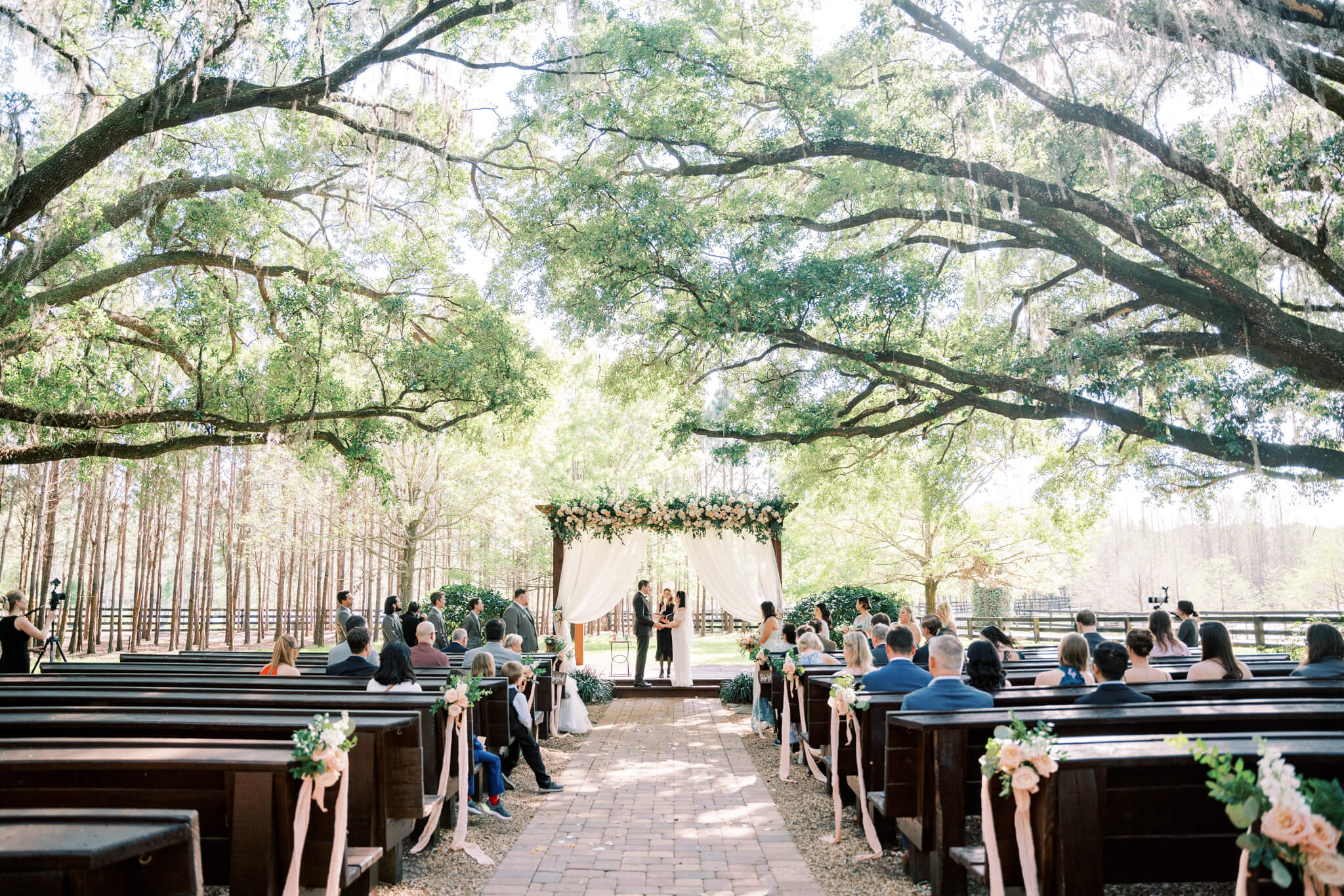 bride and groom hold hands during ceremony at an outdoor wedding venue in Central FL
