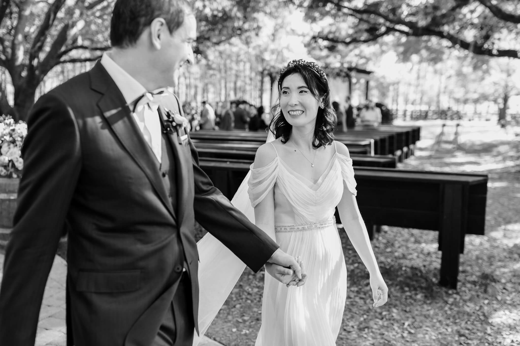 Bride and groom smiling as they walk out the ceremony