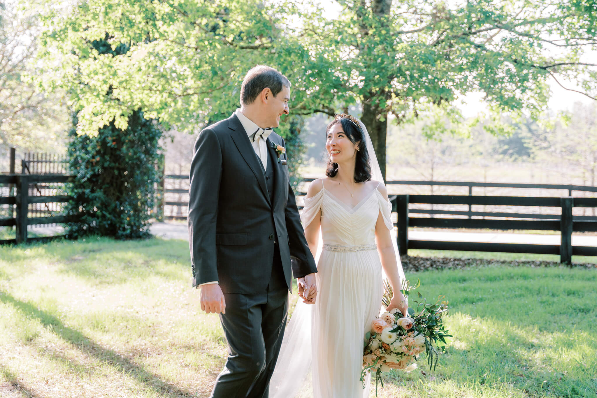 Bride and groom walk in a lush garden at an Orlando wedding venue