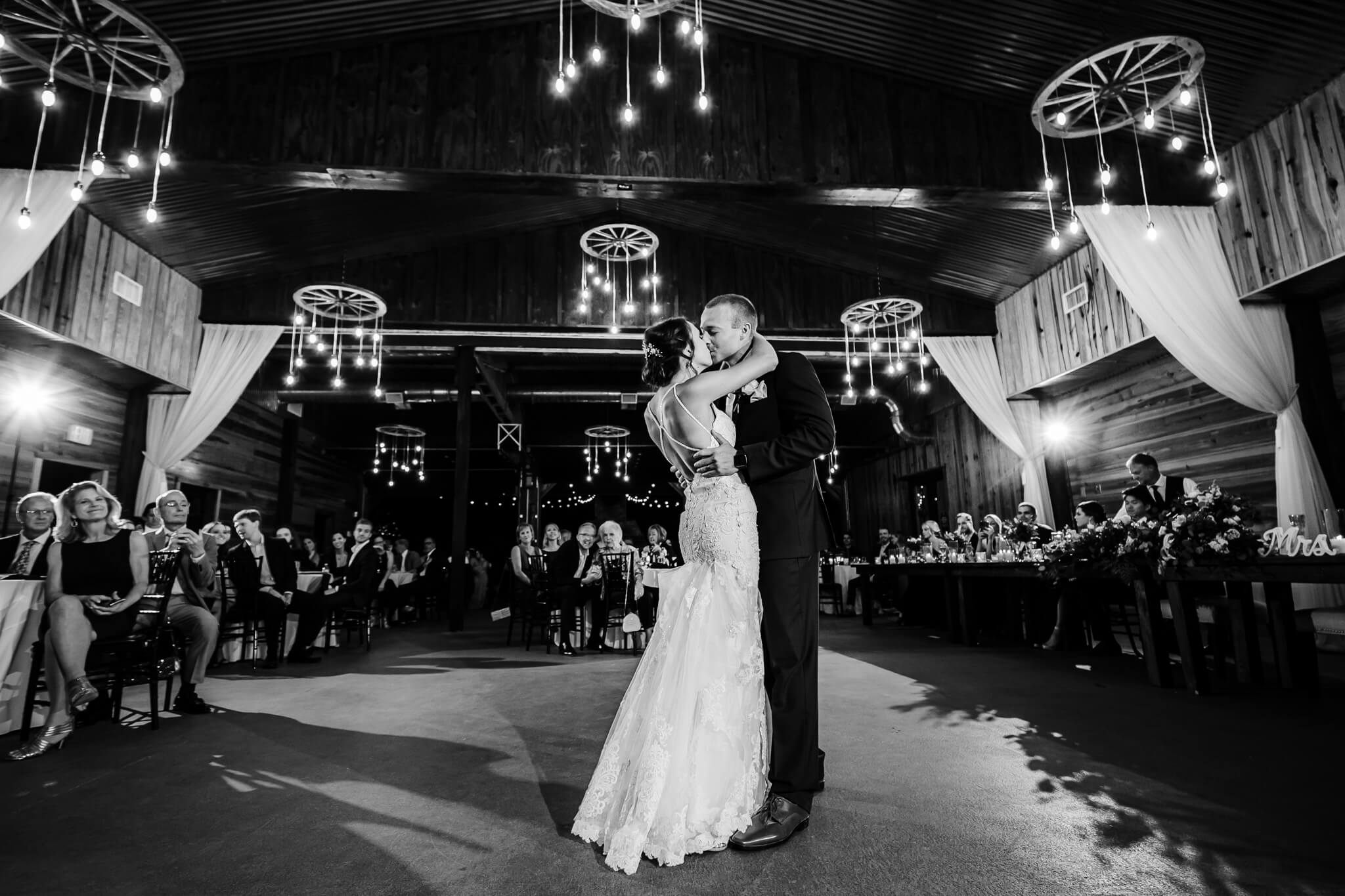 Bride and groom kiss during their first dance at Club Lake Venue, an outdoor wedding venue in Central FL