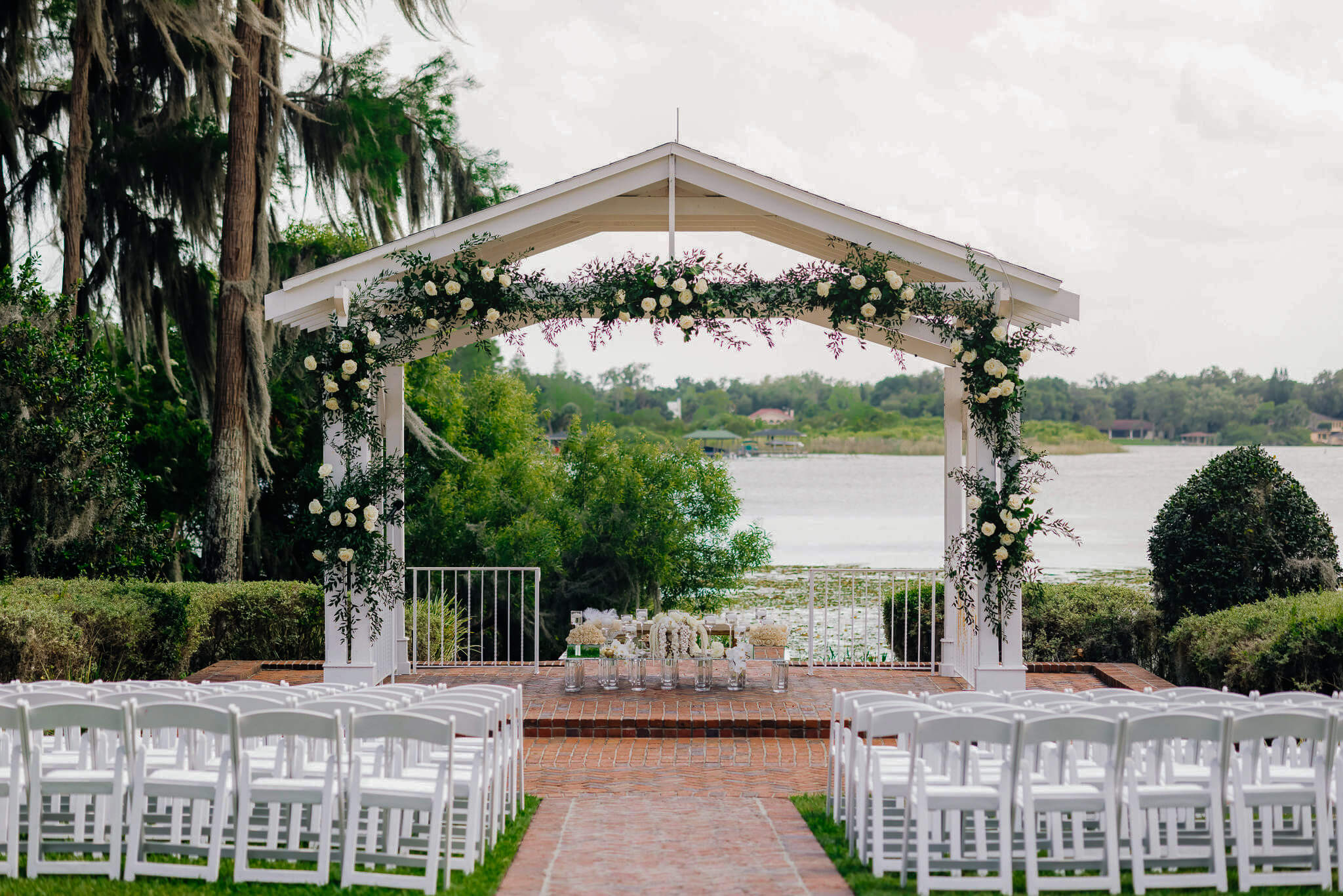 Outdoor ceremony with a lake view at an Orlando wedding venue