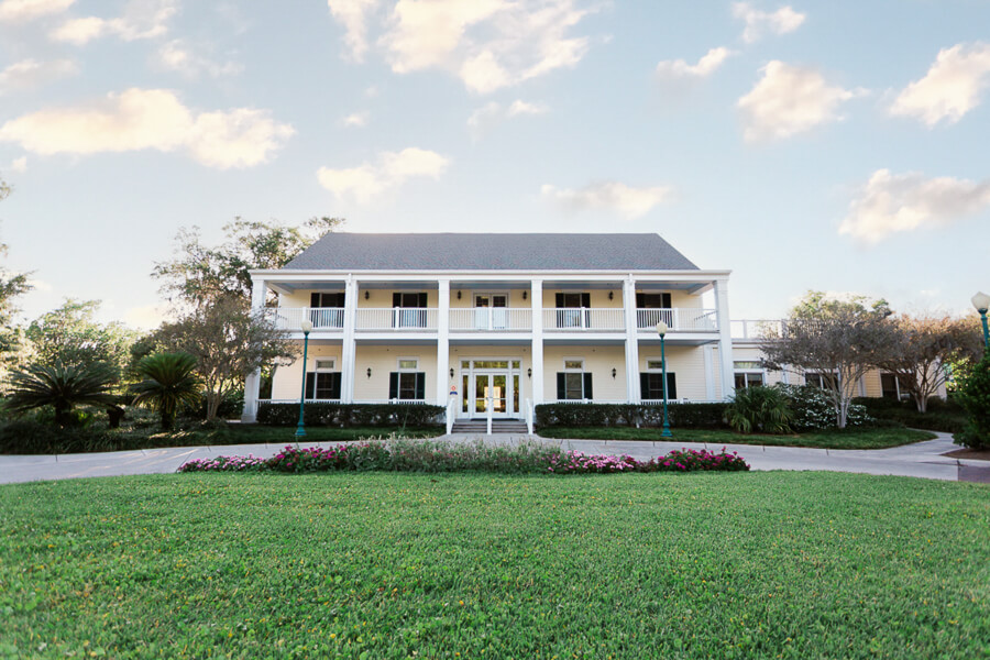 estate mansion wedding venue called Leu Gardens with large green lawn under beautiful sky