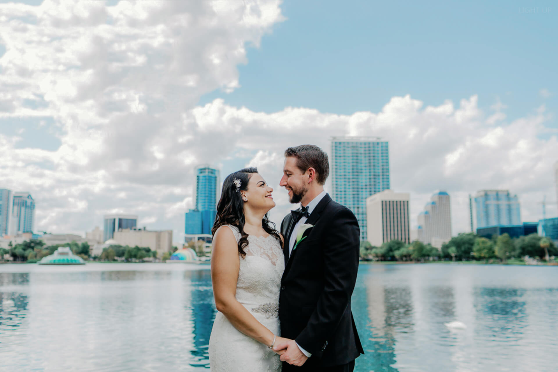 bride and groom pose for portrait at Lake Eola, a popular elopement venue in Orlando