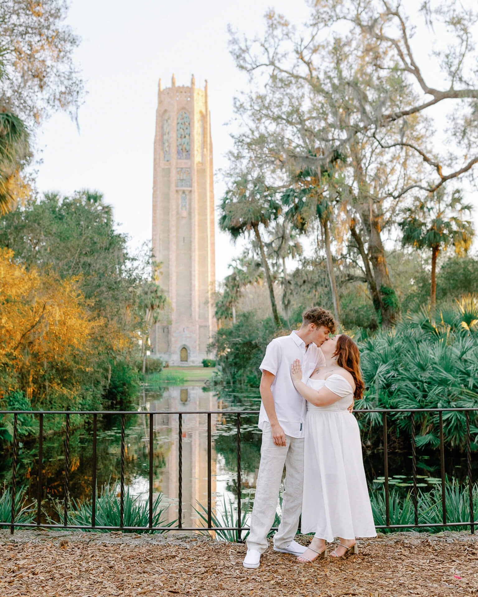 couple poses in front of a pond at Bok Tower during their elopement