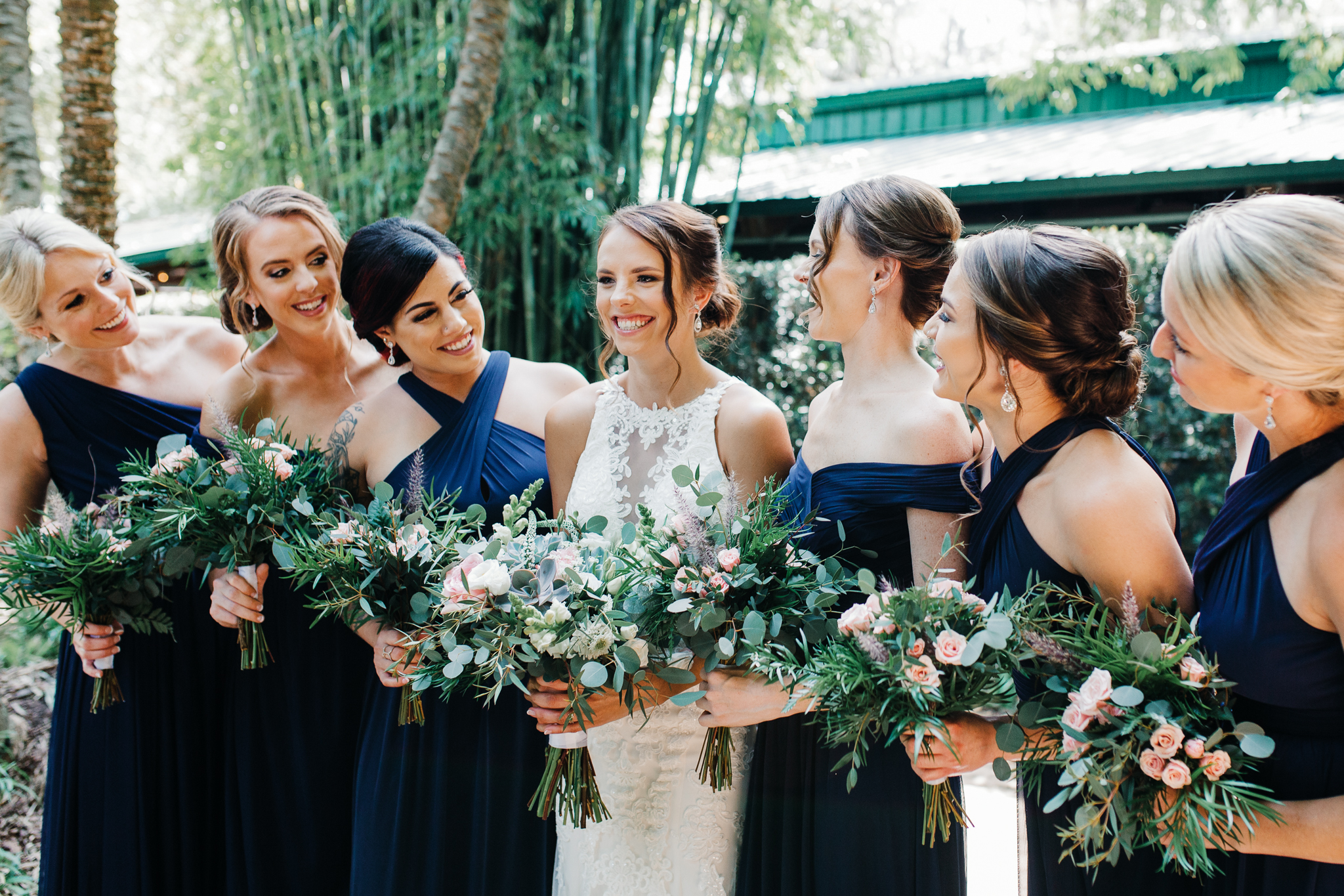 Bride and bridesmaids posing for portrait at Club Lake Wedding Venue