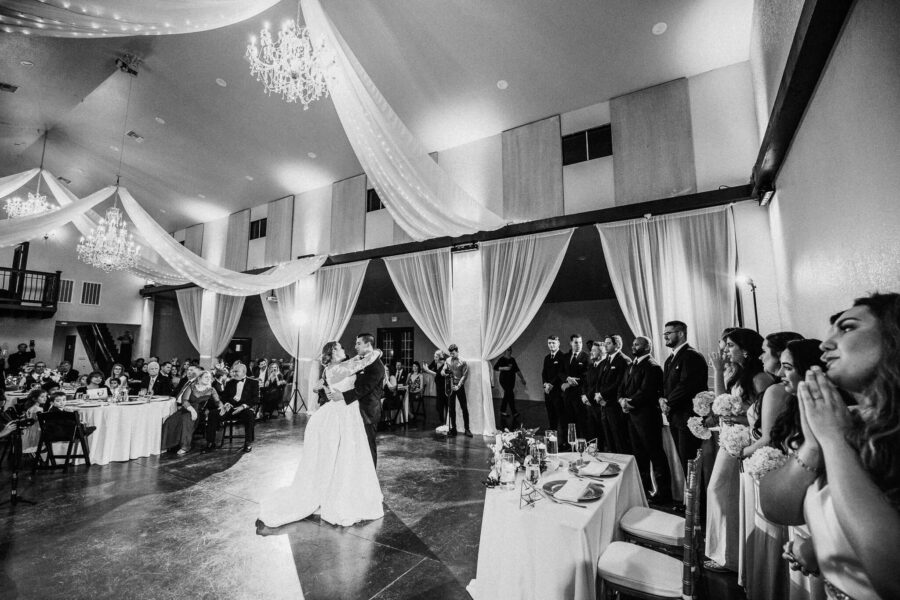 bride and groom dancing while crowd watches