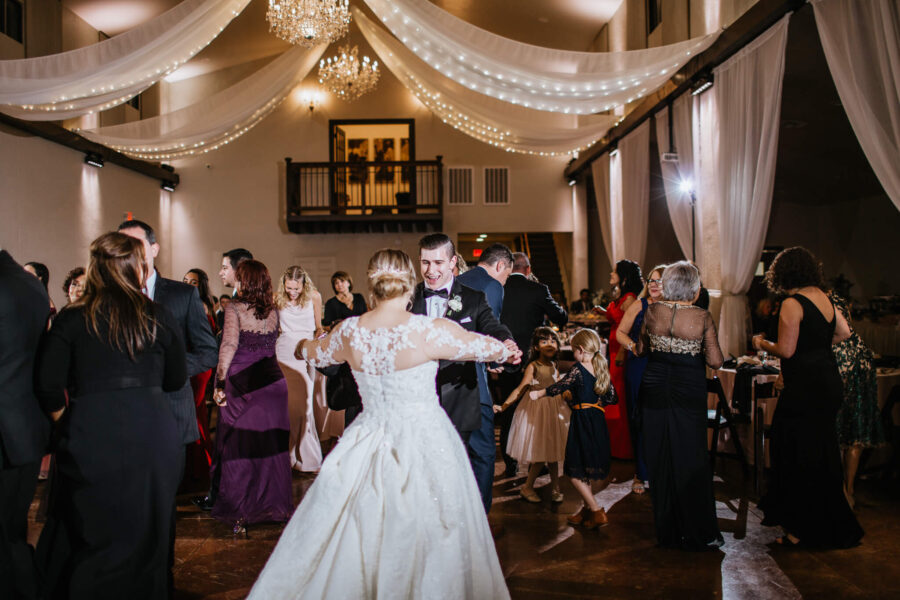 groom smiling while dancing with bride at Bakers Ranch wedding venue