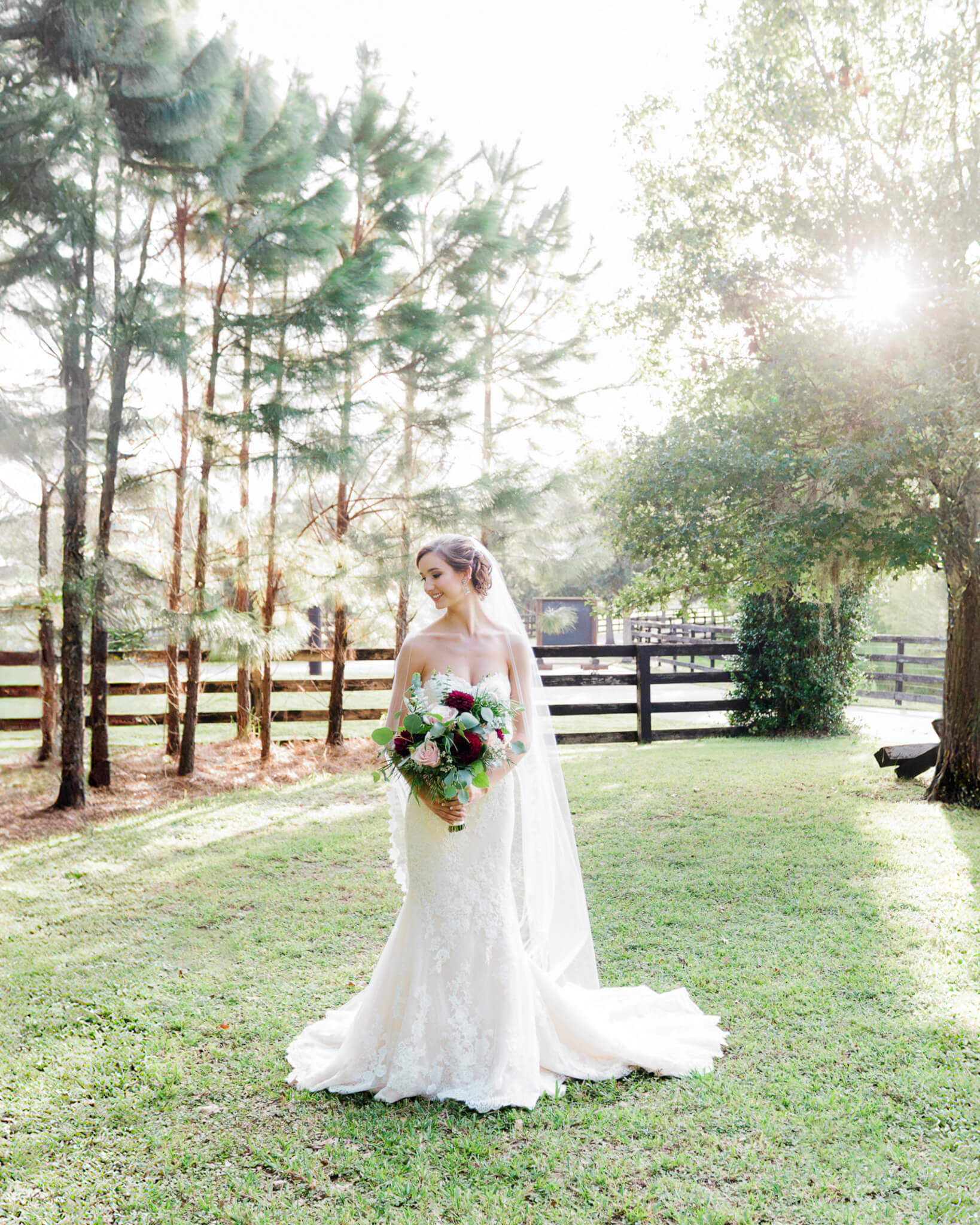 Bride holding wedding bouquet and posing for portrait at Club Lake