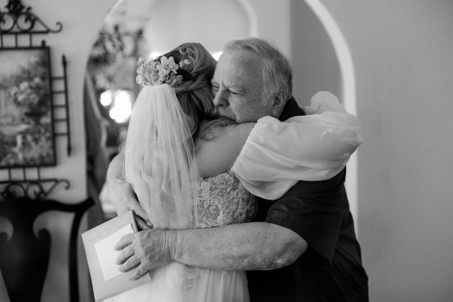 bride hugs father and share emotional moment