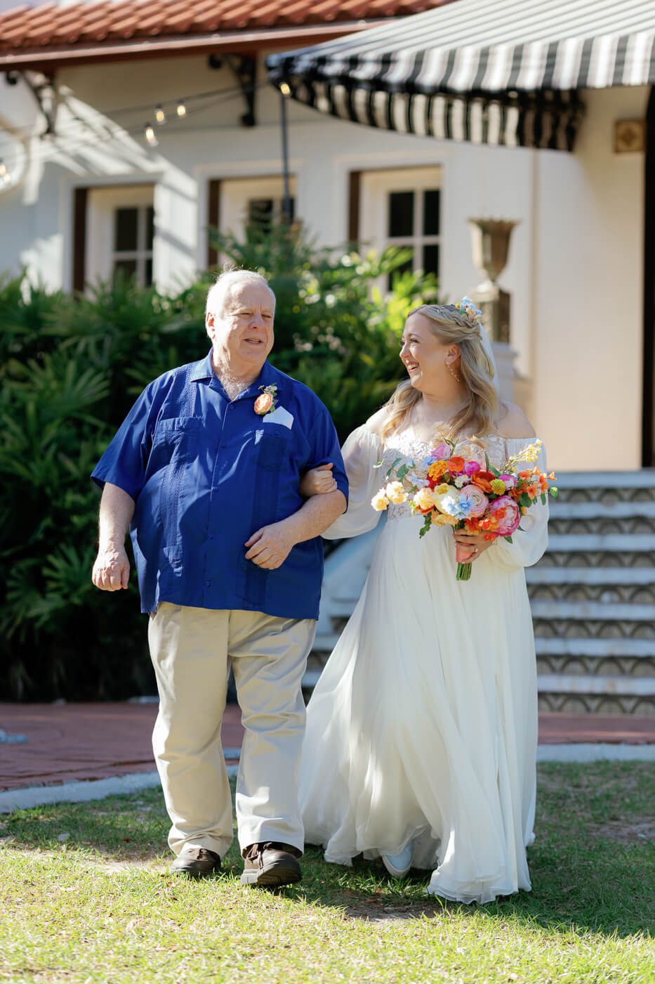 bride walks down the aisle with her father