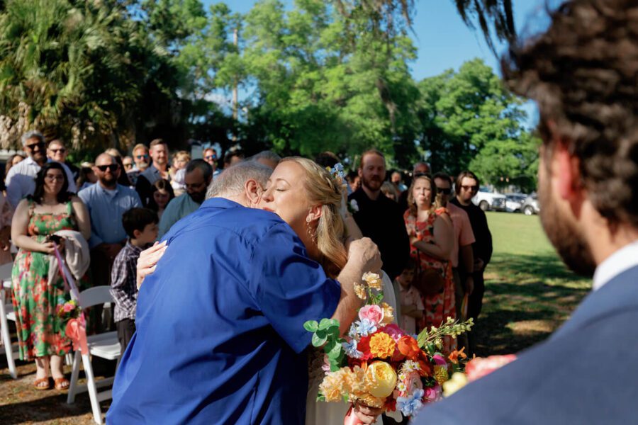 bride hugs father before meeting with groom