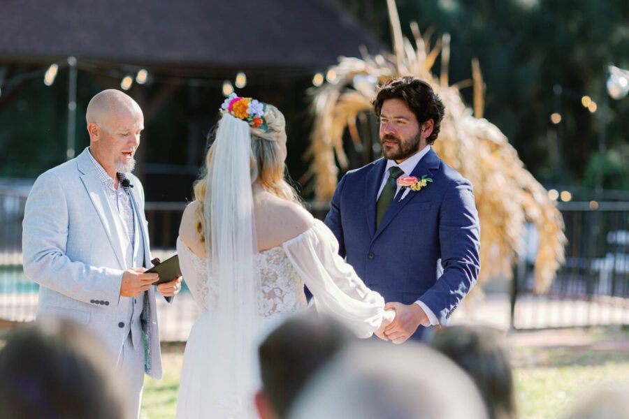 Groom looks at bride during wedding ceremony