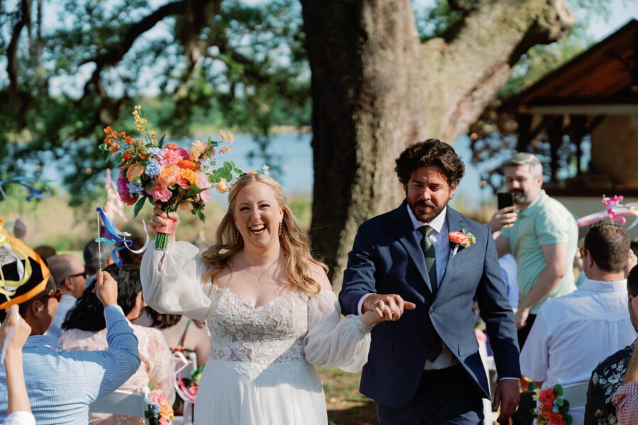 Bride and groom walking out the aisle at Lake Lucy Estate wedding