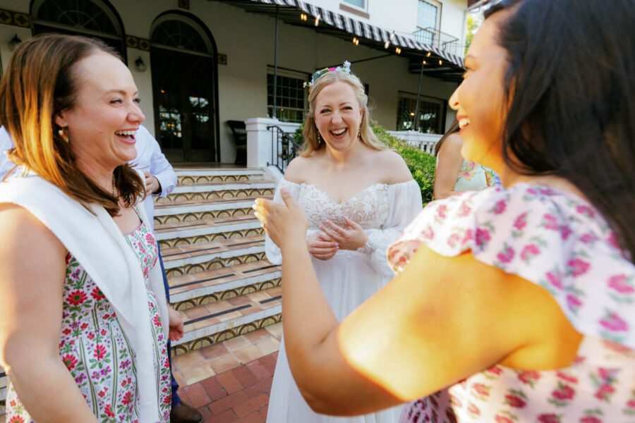 bride laughing with friends during cocktail hour