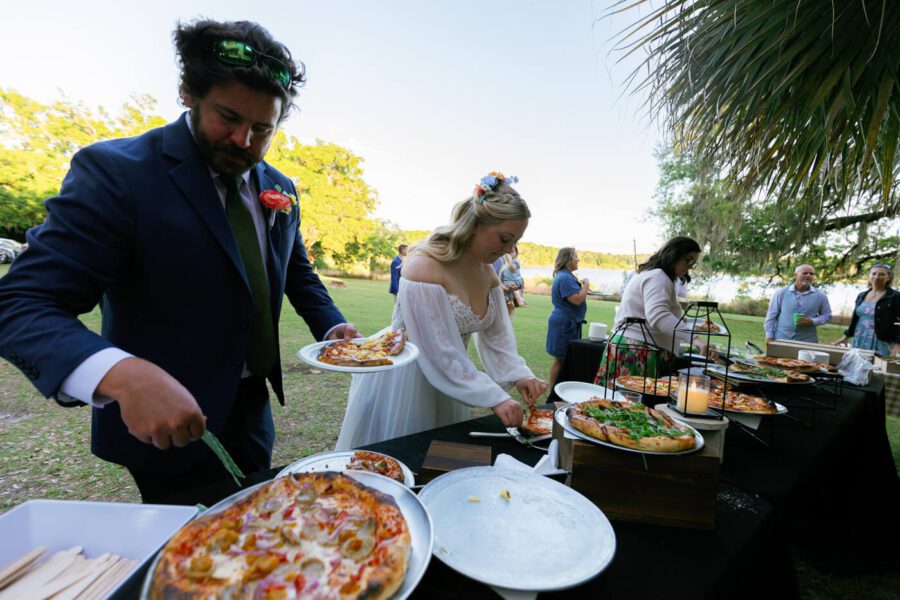 Groom and bride getting a slice of pizza