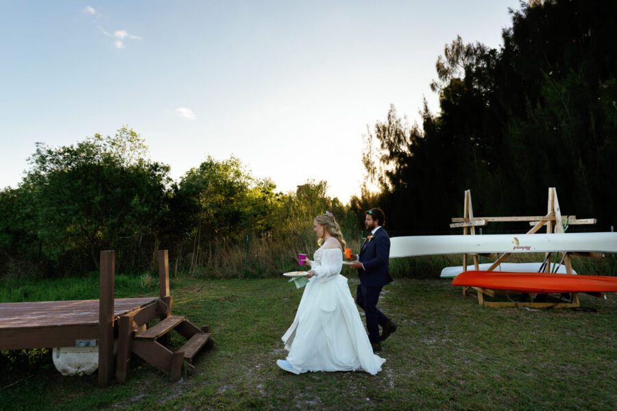 bride and groom walking towards a dock